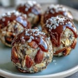 Nut-free energy balls with oats and honey, packed with seeds and mini chocolate chips for a wholesome, chewy snack.
