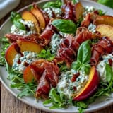 Juicy Peach Burrata Prosciutto Salad, featuring savory prosciutto and fresh basil, ready to enjoy.