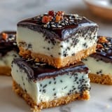 Decadent black sesame cheesecake bars, creamy and nutty, topped with seeds.