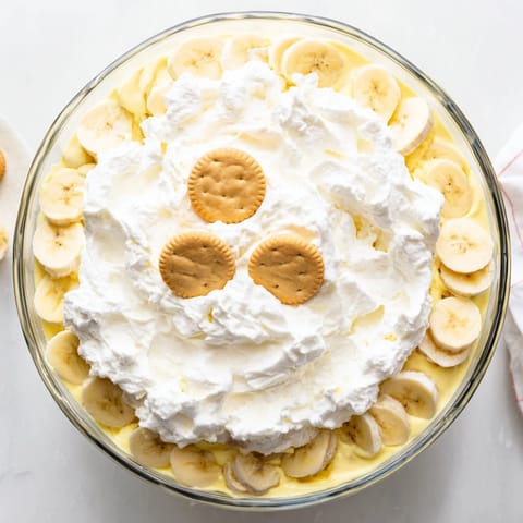 Homemade Banana Pudding with crisp vanilla wafers, ripe bananas, and smooth custard in a glass serving dish, ready to serve chilled.