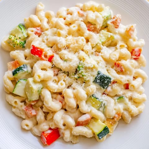 Roasted Veggie Mac & Cheese served hot, featuring tender elbow noodles mixed with colorful roasted tomatoes and onions.