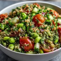 Vibrant Edamame and Quinoa Salad glistening with tangy citrus dressing, ready to serve.