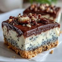 Luscious black sesame cheesecake bars with a crisp cookie base, ready to slice.